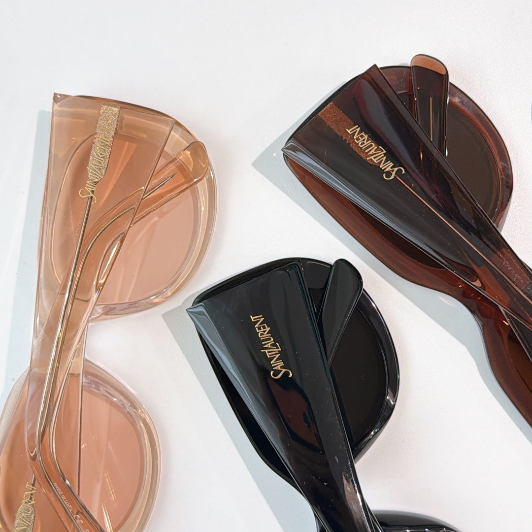 Stacked sunglasses: translucent beige pair and dark brown pair with black lenses.