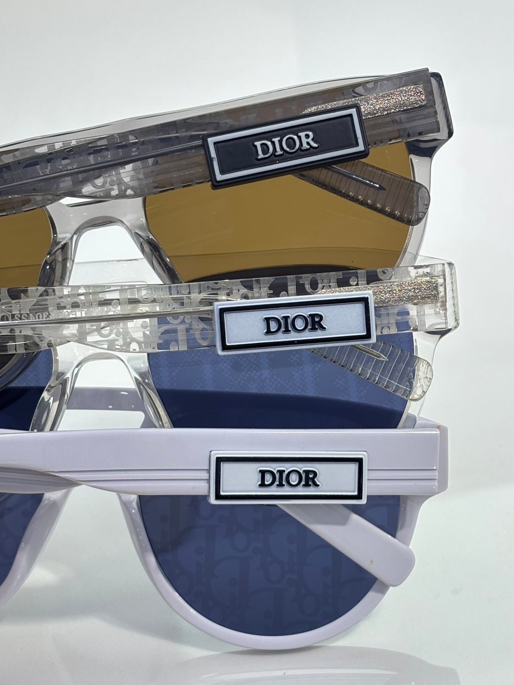 Dior sunglasses with clear frames and dark blue tinted lenses