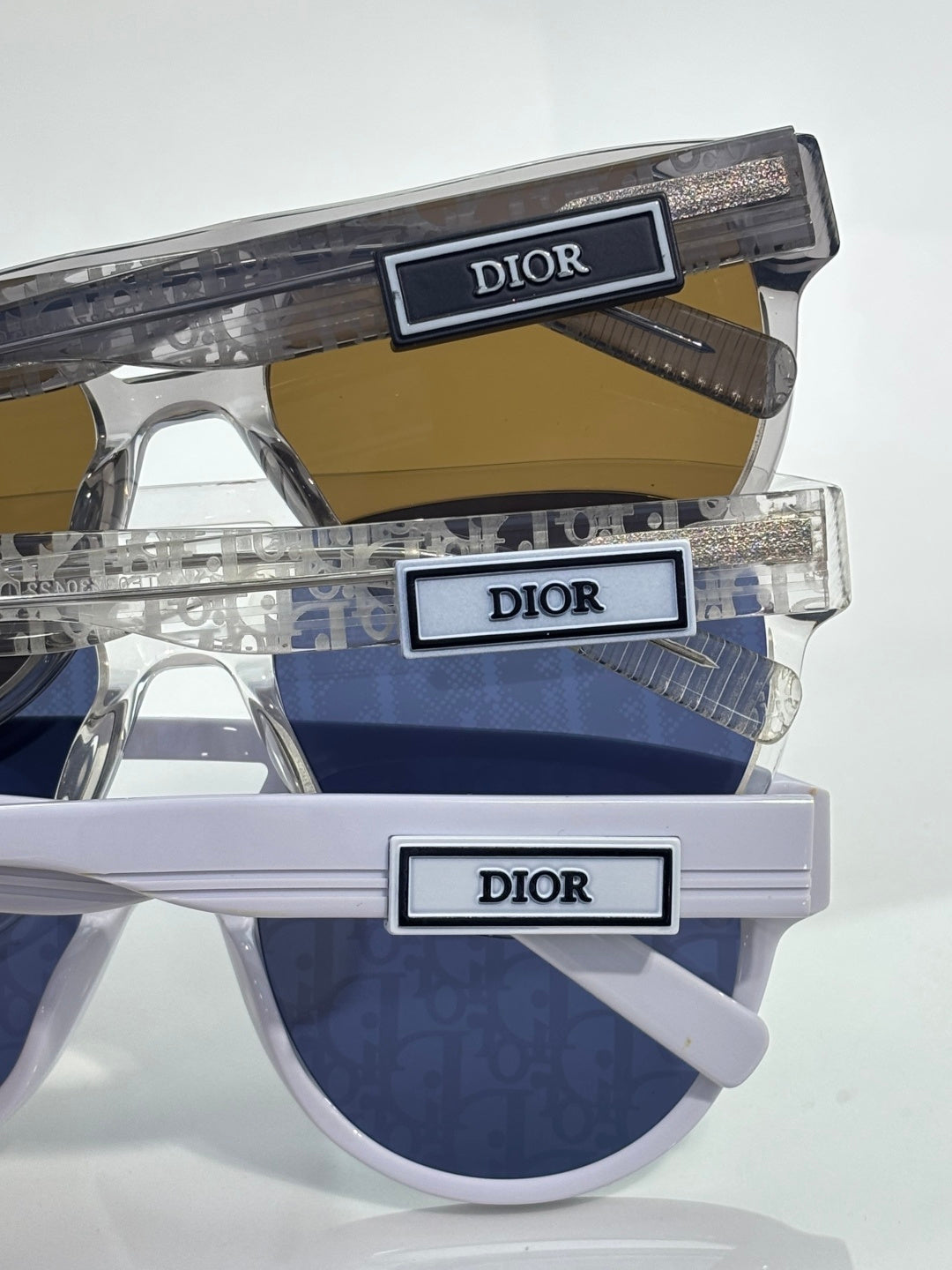 Dior sunglasses with clear frames and dark blue tinted lenses