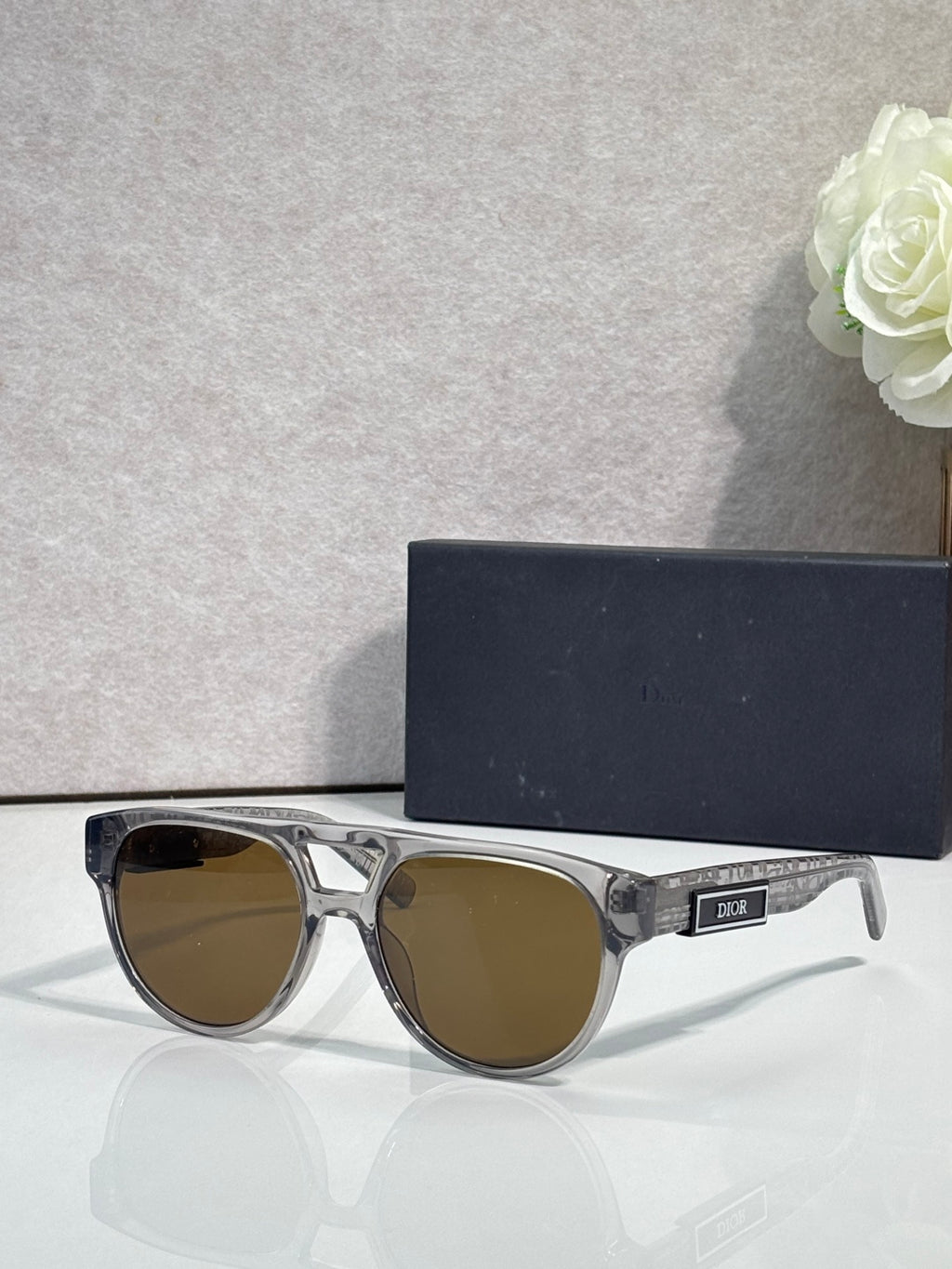 Dior sunglasses with clear silver frames and brown tinted lenses