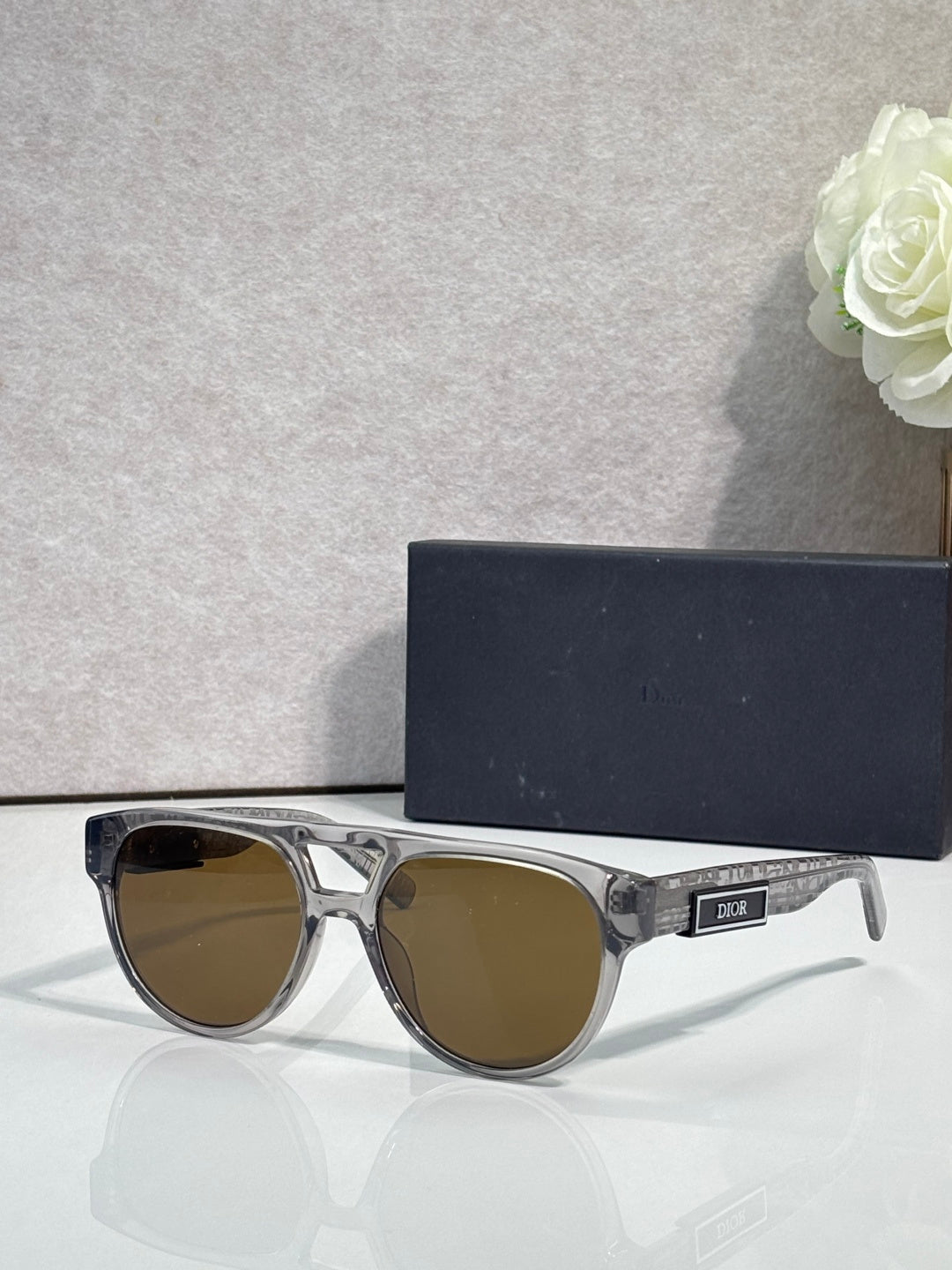 Dior sunglasses with clear silver frames and brown tinted lenses
