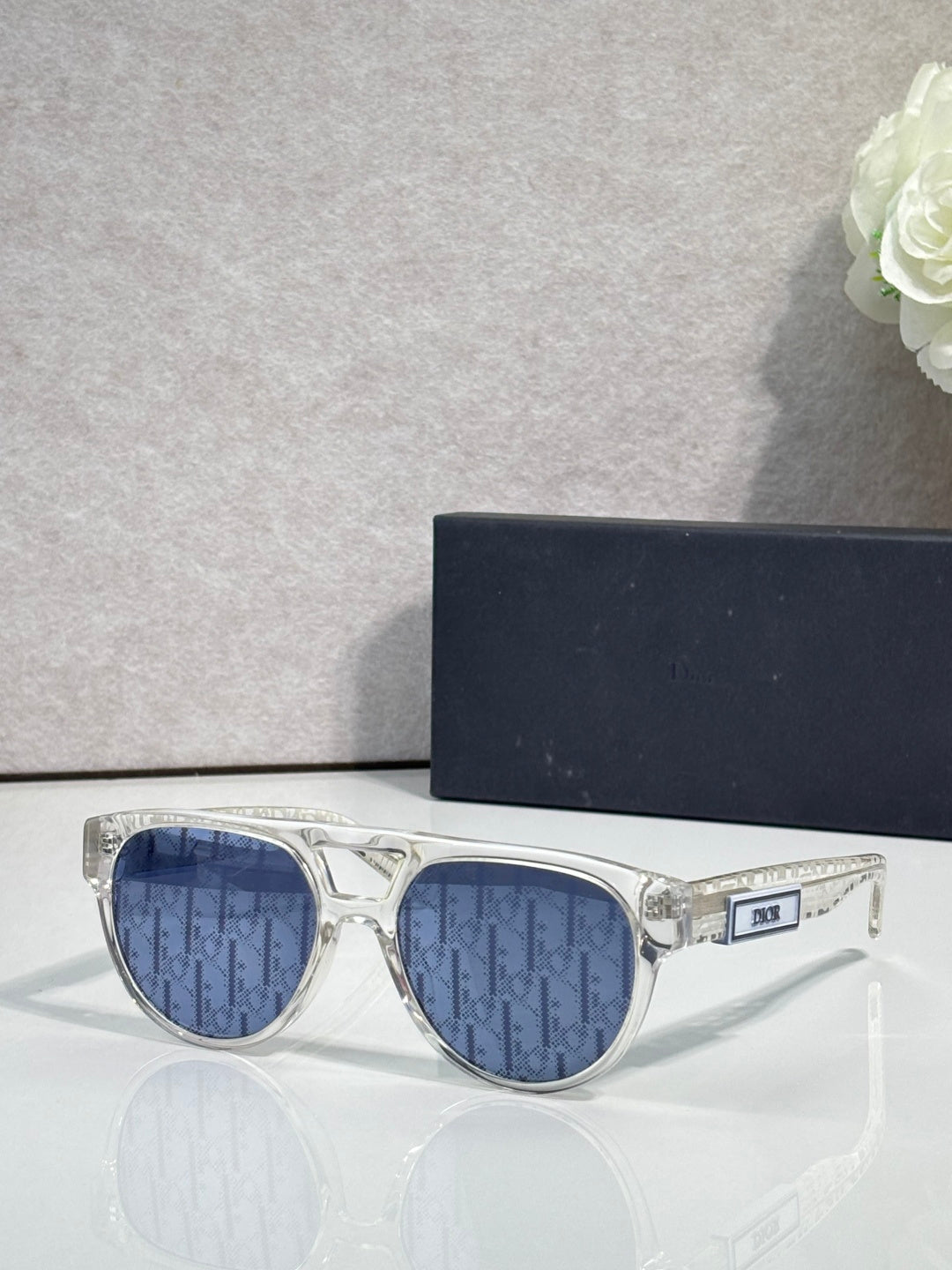 Dior sunglasses with clear frames and blue tinted lenses