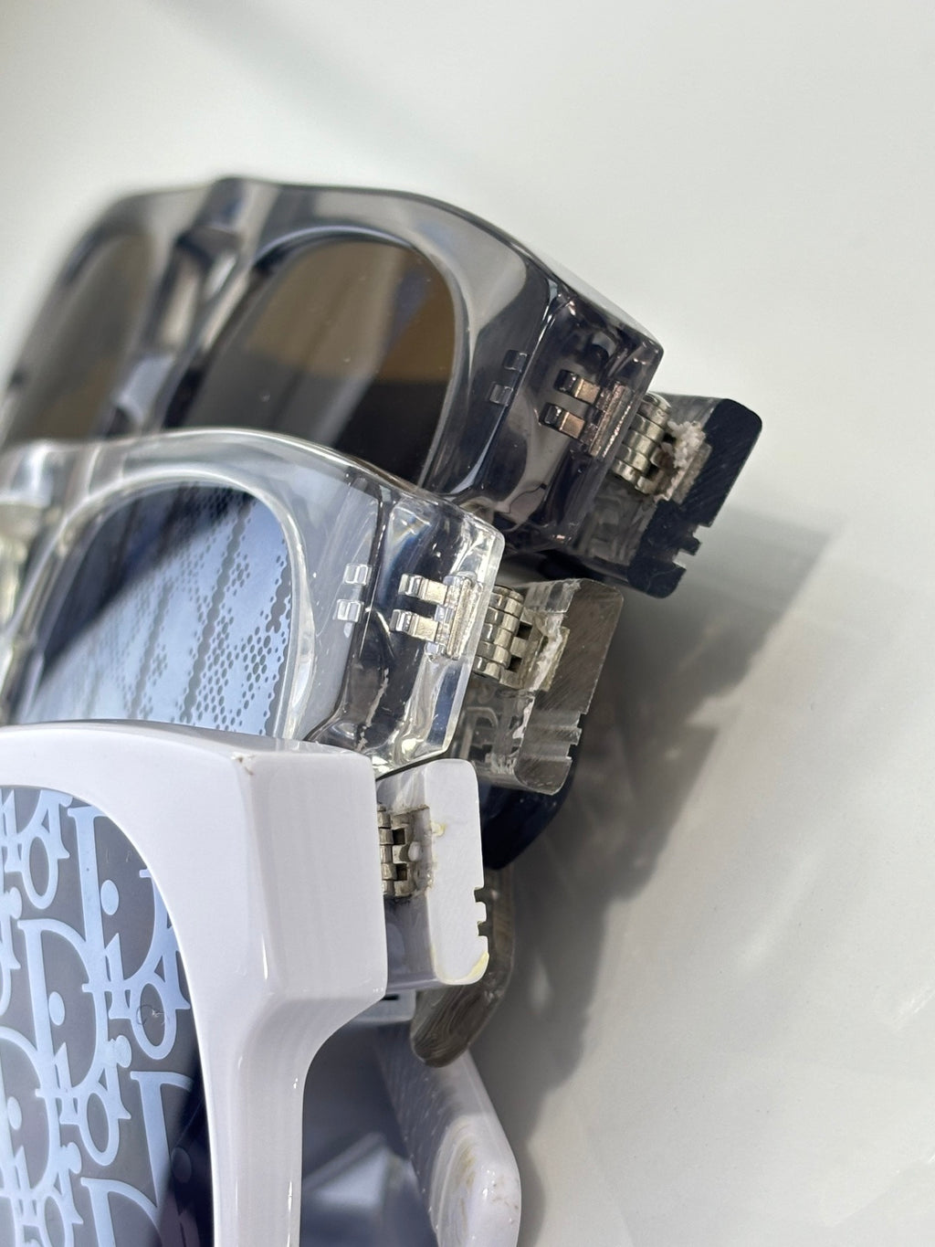 Dior sunglasses close-up with transparent frame and blue patterned lens