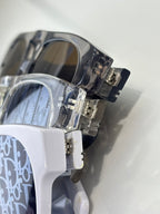 Dior sunglasses close-up with transparent frame and blue patterned lens