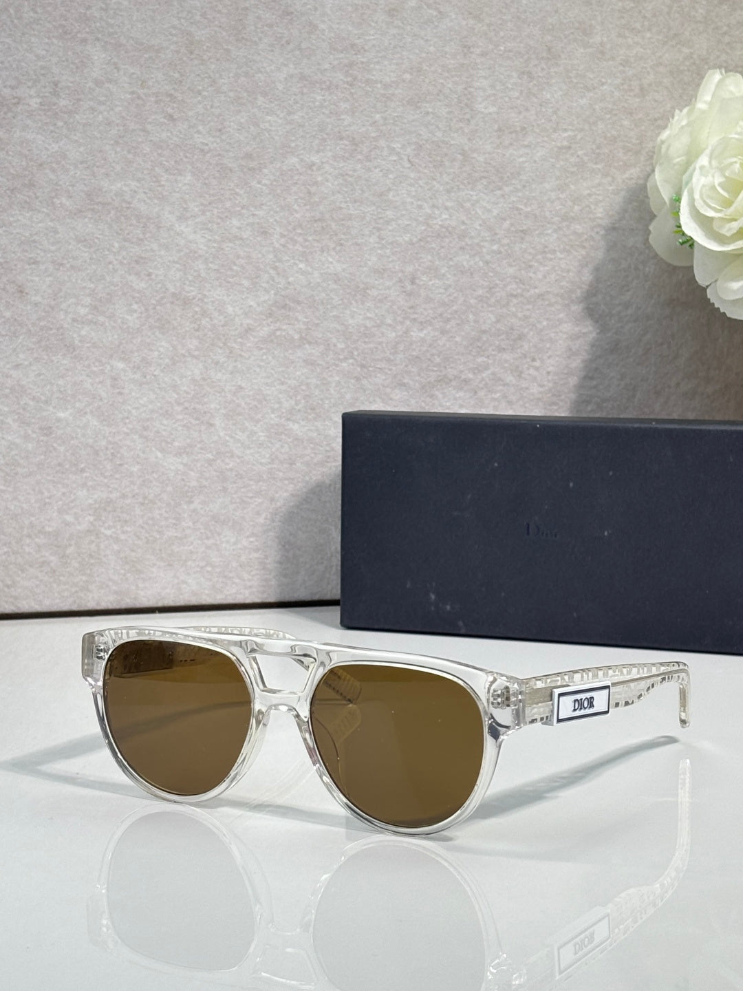 Dior sunglasses with clear silver frames and brown round lenses