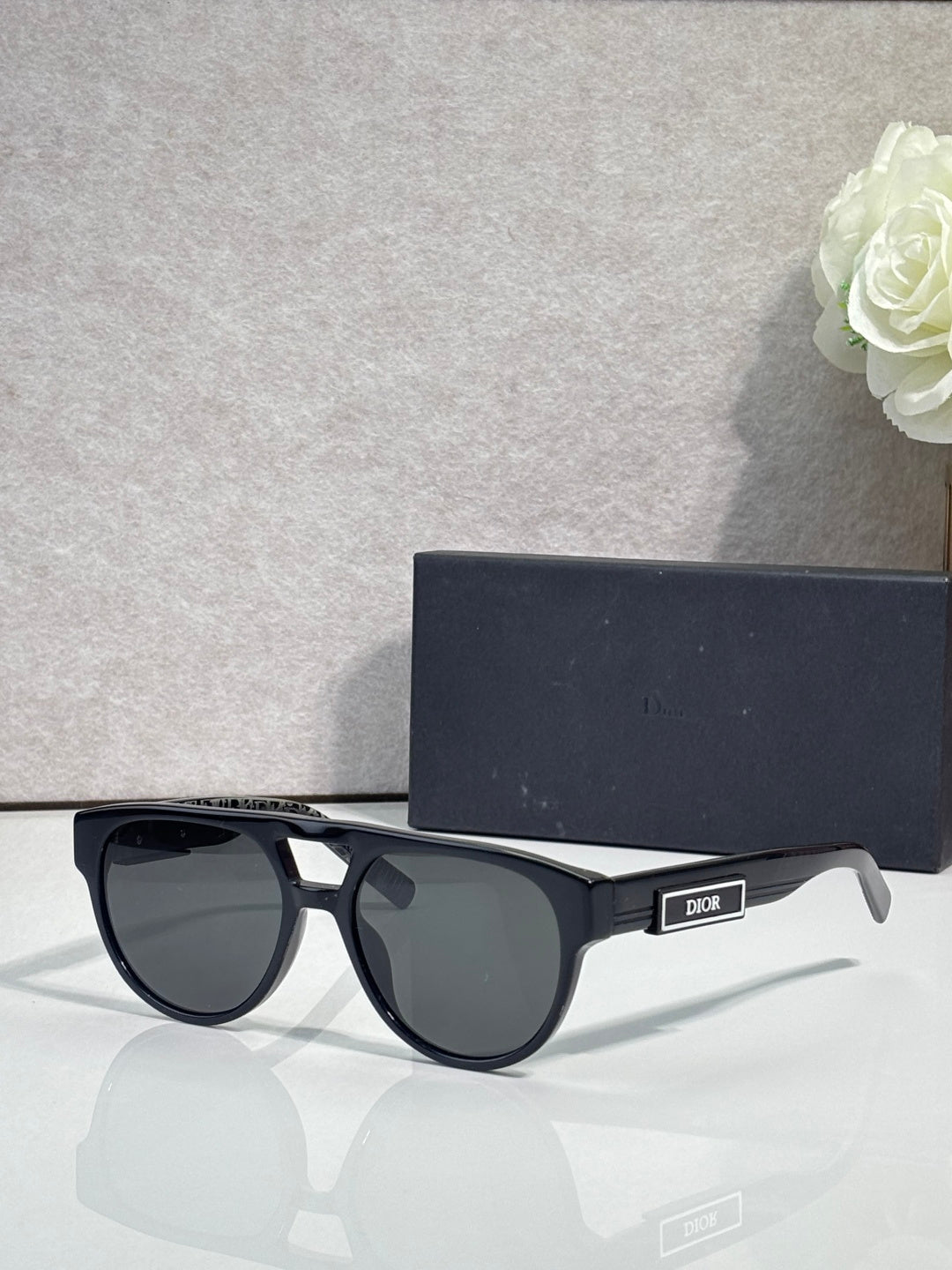 Dior sunglasses with black oval frames and dark lenses
