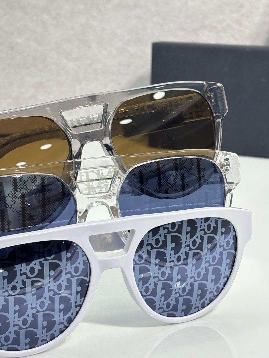 Dior sunglasses with transparent frames and blue patterned lenses
