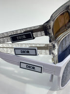 Dior sunglasses with clear temple detail and warm brown tinted lenses
