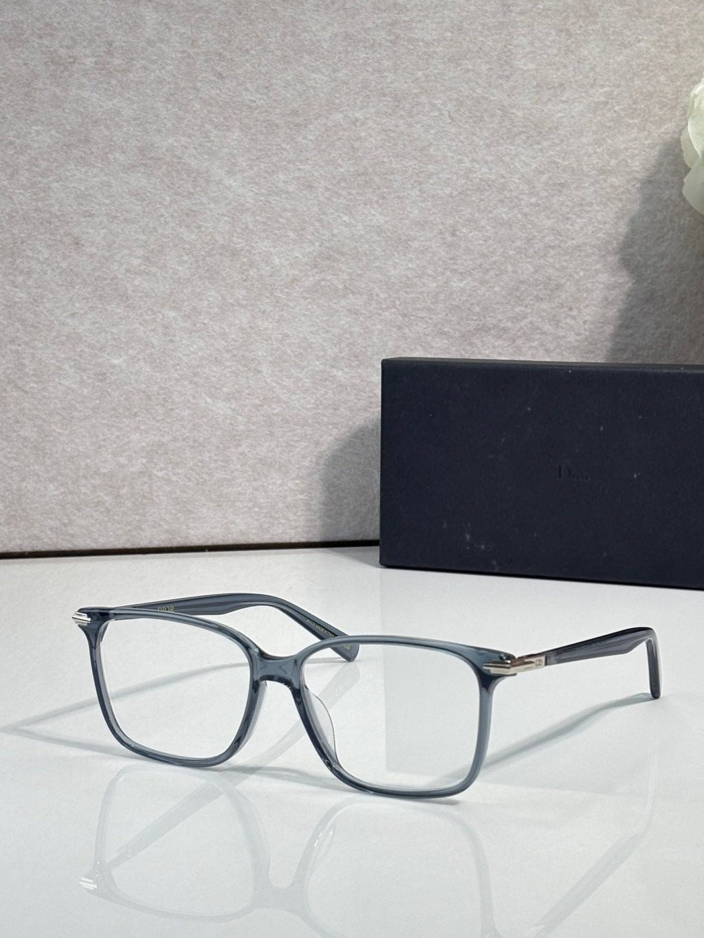 Dior eyeglasses with blue-gray rectangular frames and clear lenses