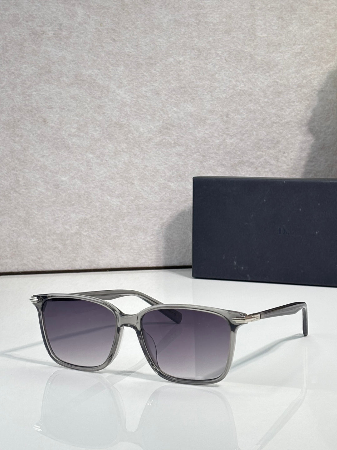 Dior eyeglasses with silver frames and purple tinted lenses