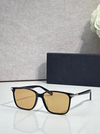Dior eyeglasses with black frames and amber tinted lenses