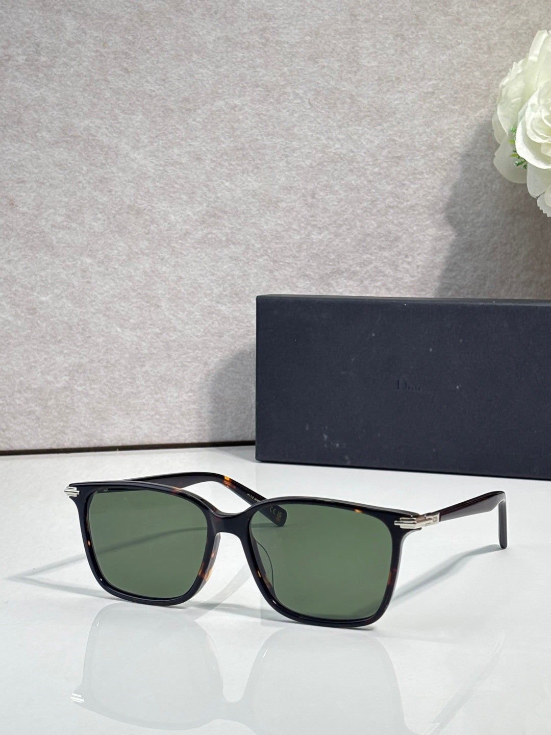 Dior eyeglasses with black frames and dark green tinted lenses