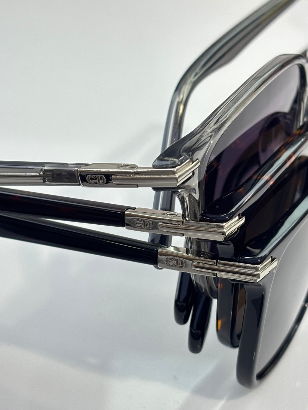 Dior eyeglasses side view with metal hinges and dark tinted lens