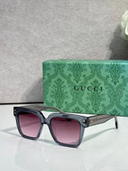 Gucci square sunglasses with pink-tinted lenses and black frame, gold stud accents on temples