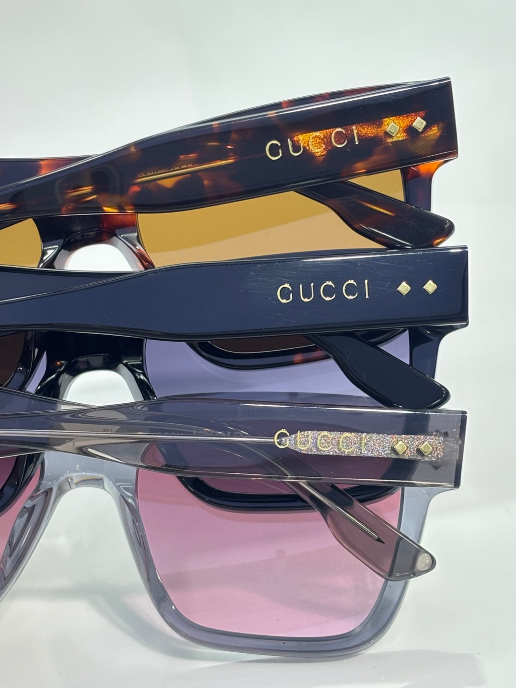 Gucci sunglasses stack with tortoiseshell top frame and dark blue frames, pink lens fronts
