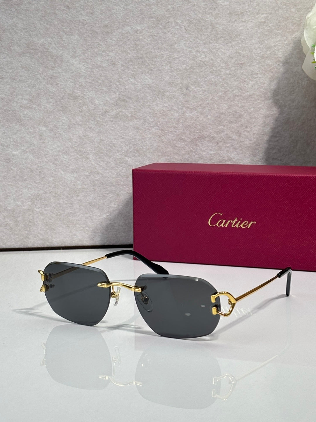Sunglasses with gold frame and dark gray mirrored lenses