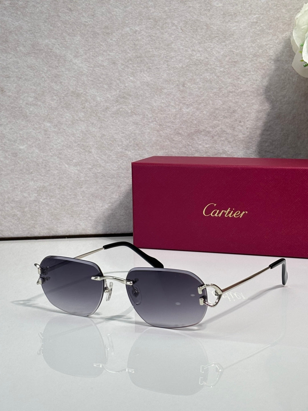 Sunglasses with silver frame and dark navy mirrored lenses