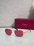 Sunglasses with gold frame and pink mirrored lenses