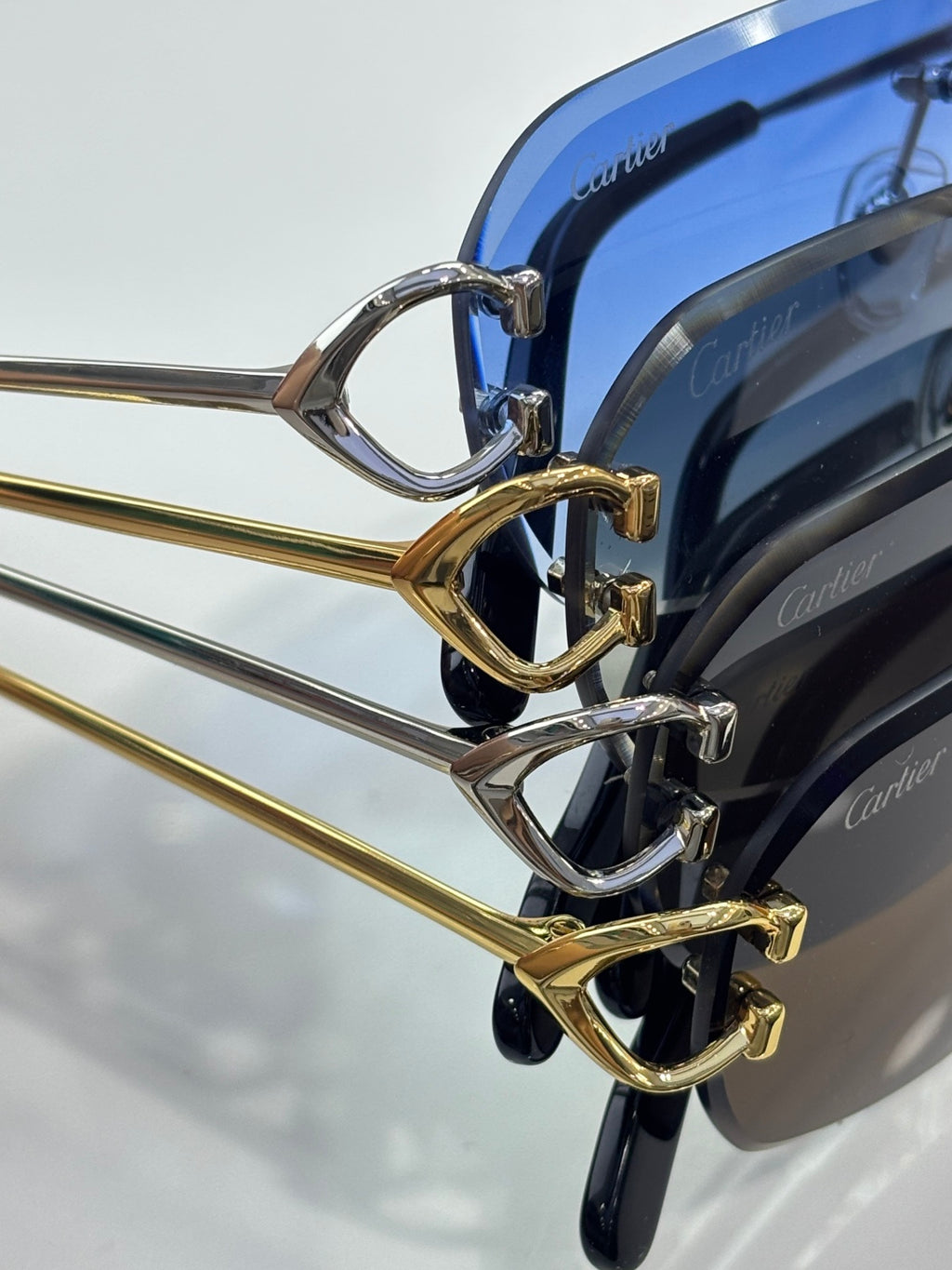 Sunglasses close-up: gold frame detail with blue-tinted lenses