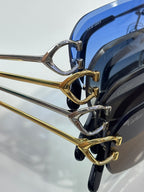 Sunglasses close-up: gold frame detail with blue-tinted lenses