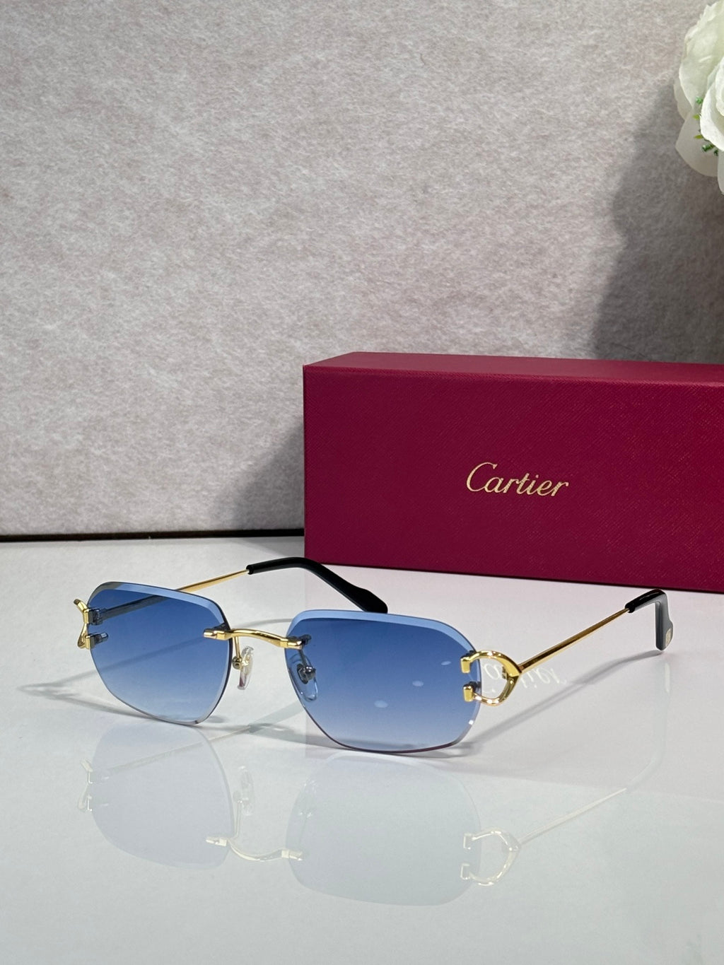 Sunglasses with gold frame and blue mirrored lenses