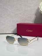 Cartier sunglasses with gold frame and light gray mirrored lenses