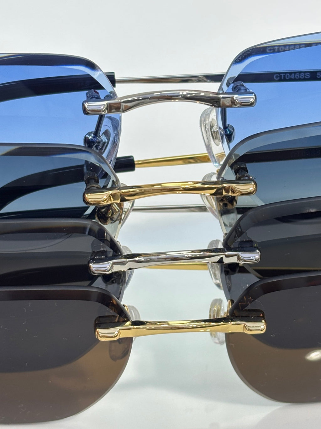 Sunglasses close-up: gold and silver temples with blue and dark lenses