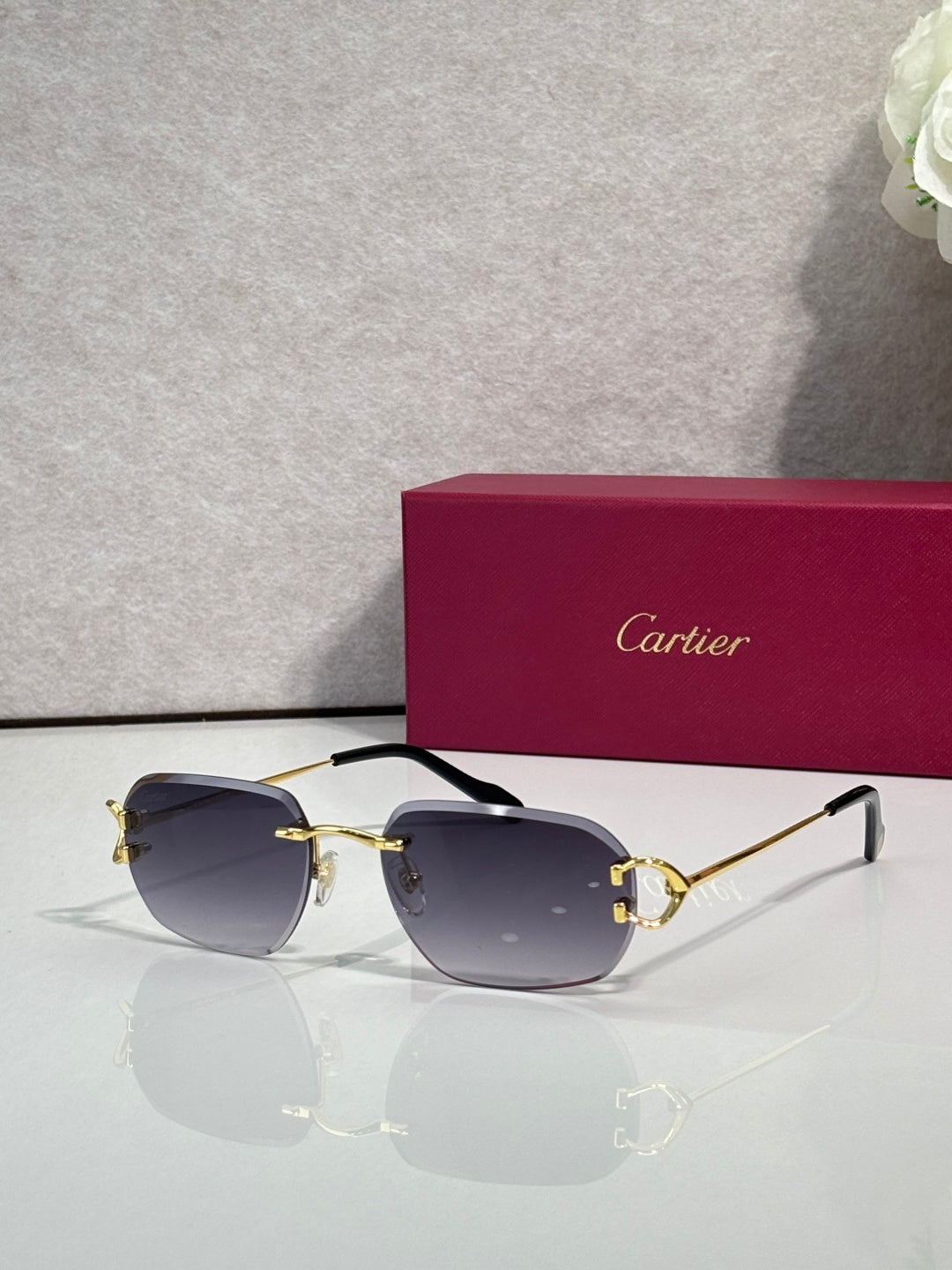 Cartier round-frame sunglasses with smoky purple lenses and gold metal accents