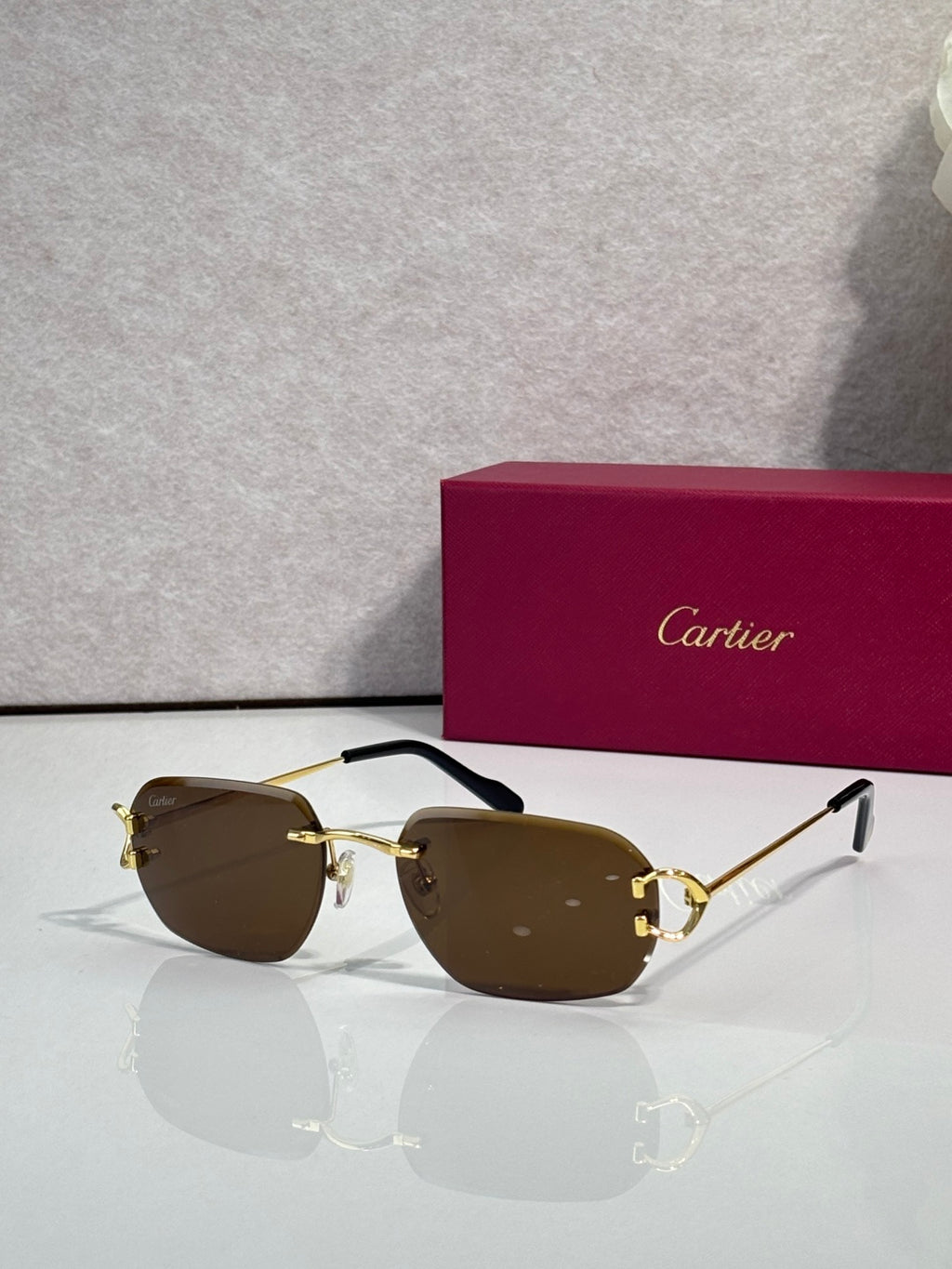 Cartier round-frame sunglasses with brown lenses and gold metal accents