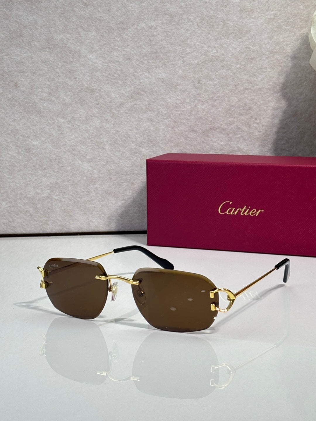 Cartier round-frame sunglasses with brown lenses and gold metal accents
