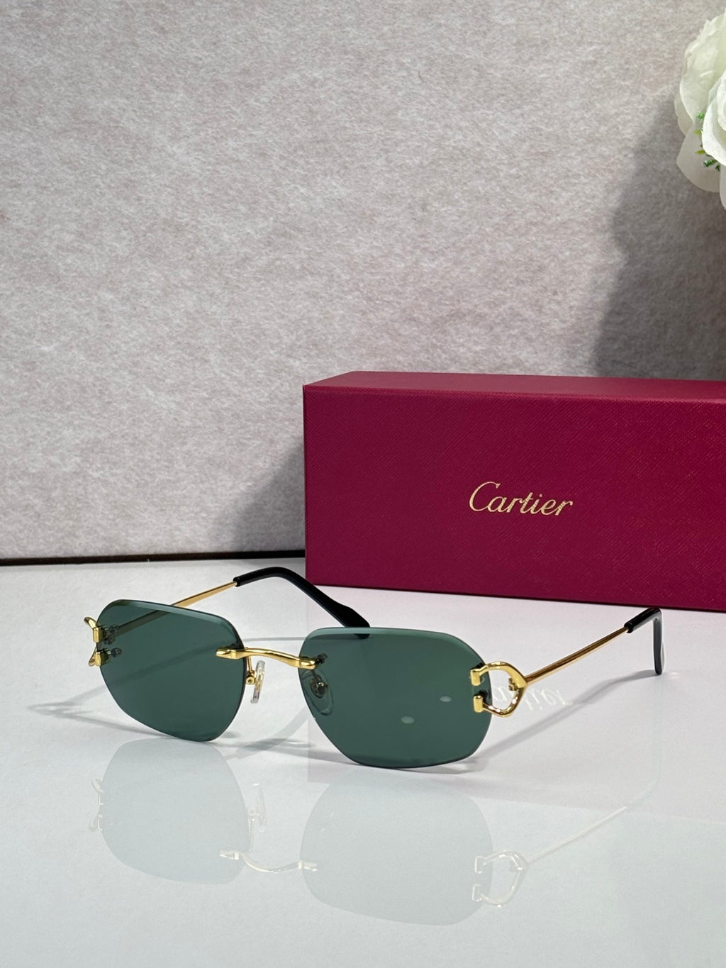 Cartier round-frame sunglasses with green lenses and gold metal accents