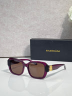 Purple square sunglasses with brown-tinted lenses and gold logo temple detail