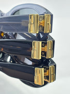 Balenciaga sunglasses close-up with blue-and-black frames and gold logo bridge