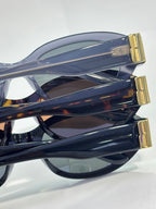 Balenciaga sunglasses side view with translucent blue frame and gold logo detail