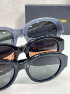 Balenciaga sunglasses close-up with translucent blue frames and dark lenses