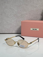 MiuMiu round eyeglasses with gold frame and clear lenses, black temple detail