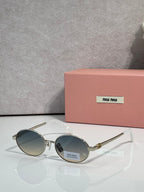 MiuMiu round sunglasses with gold frame and blue lenses, black temple detail