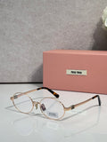 MiuMiu round eyeglasses with gold frame and clear lenses, black temple tips