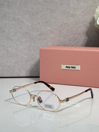 MiuMiu round eyeglasses with gold frame and clear lenses, black temple tips