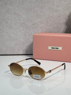 MiuMiu round sunglasses with gold frame and amber lenses, black temple detail