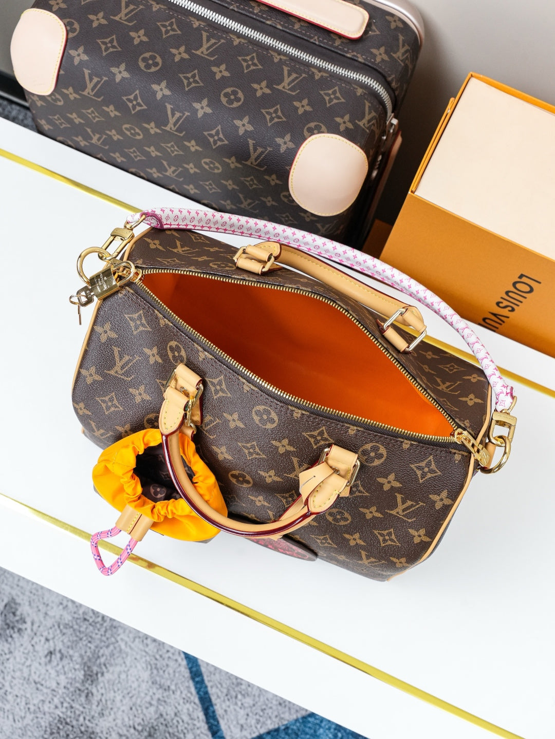 Louis Vuitton monogram canvas crossbody bag with open zipper showing tan interior lining