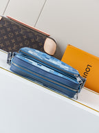 Blue checkered crossbody bag with multiple zipper pockets and silver zipper pulls