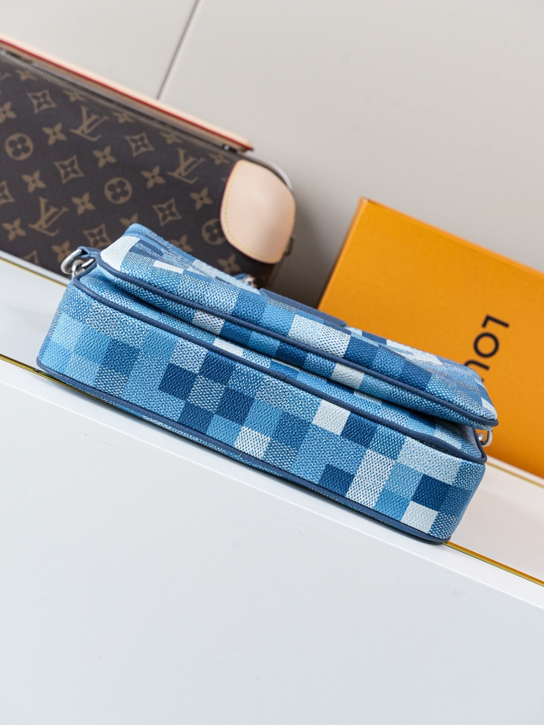 Blue checkered crossbody bag with long zipper and navy side panel