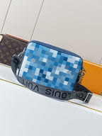 Blue checkered crossbody bag with dual zippers and black strap with printed text