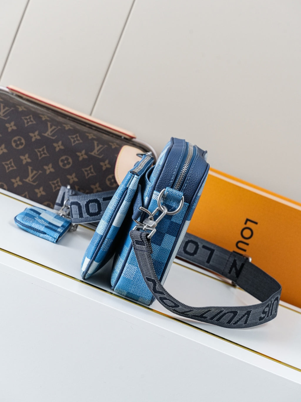 Blue checkered crossbody bag with wide strap and silver D-ring hardware