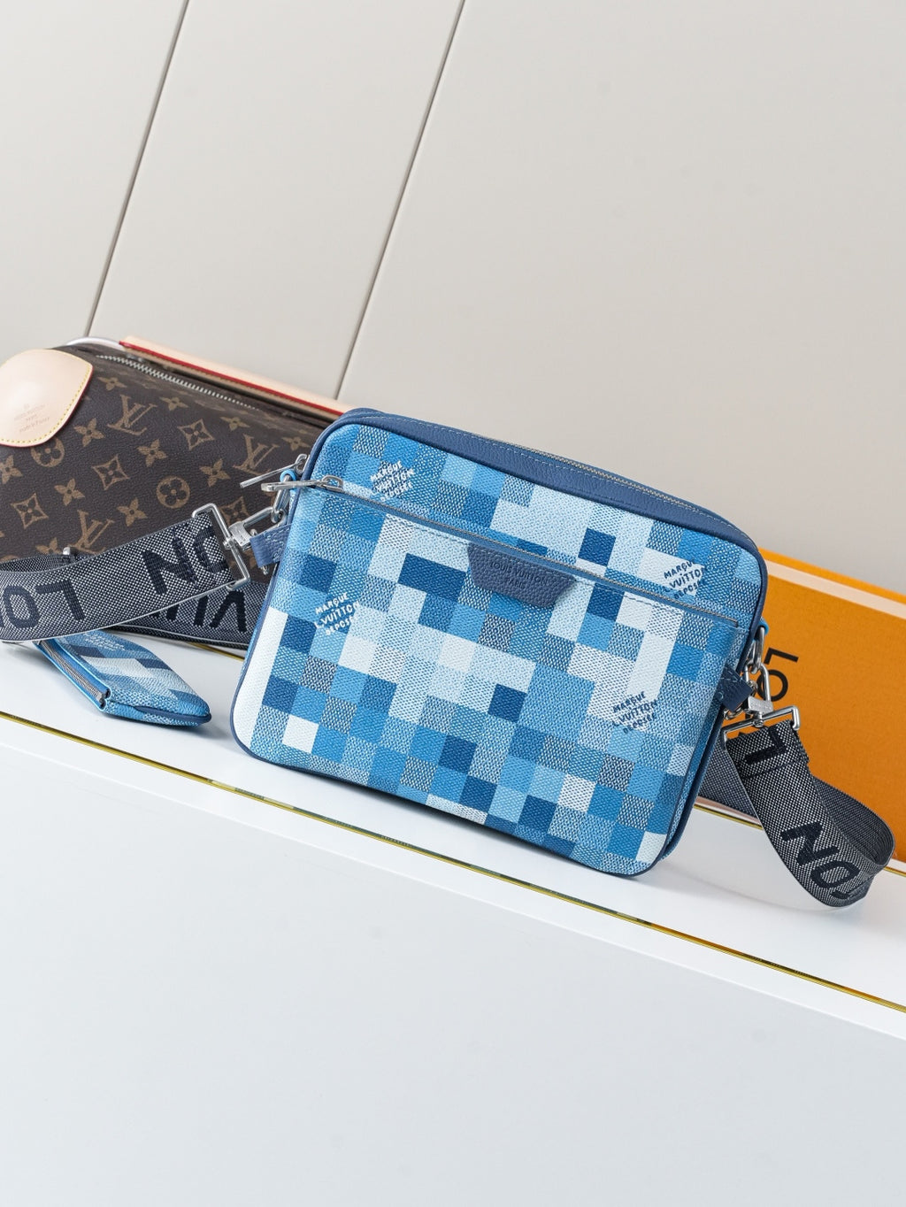 Blue checkered crossbody bag with zipper top and adjustable strap