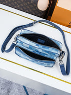 Blue check-pattern crossbody bag with two zip pockets and blue shoulder strap