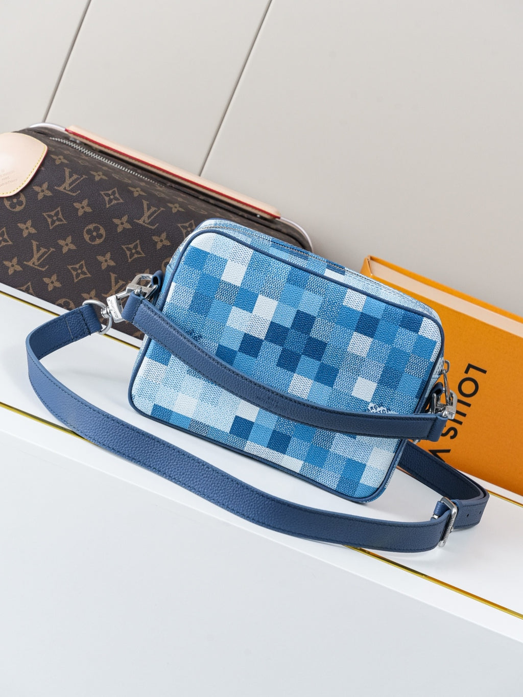 Blue check-pattern crossbody bag with two zip compartments and adjustable strap