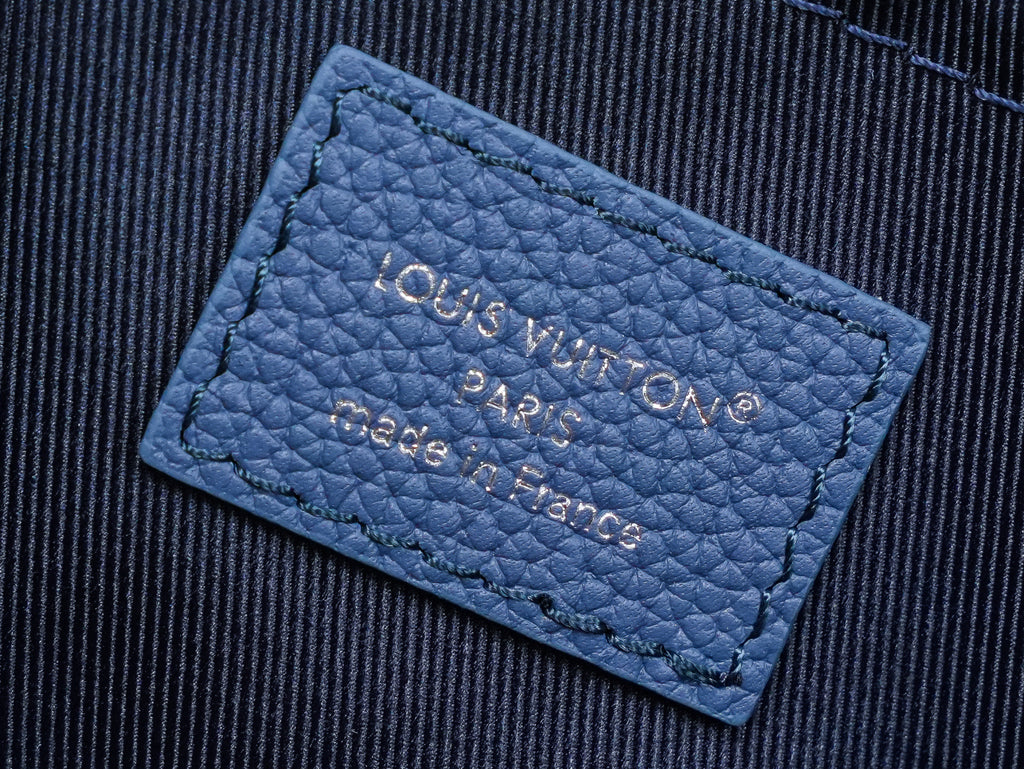 Blue leather interior label reading “Louis Vuitton Paris” with “made in” line