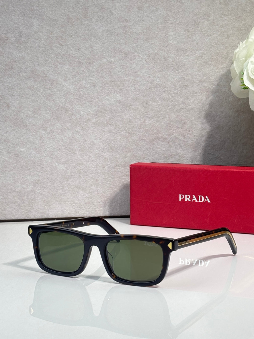 Prada rectangular eyeglasses, black frame, deep green-tinted lenses
